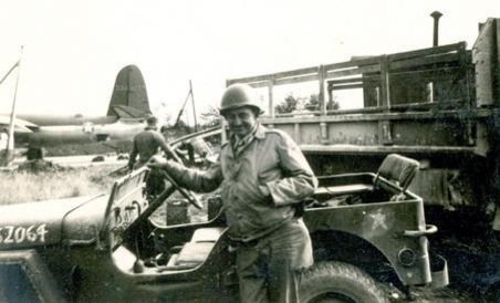 Cpl. Paul Thibodeaux stands in front of a jeep at one of the airfields built in Europe by the 843rd Engineer Aviation Battalion during World War II.
